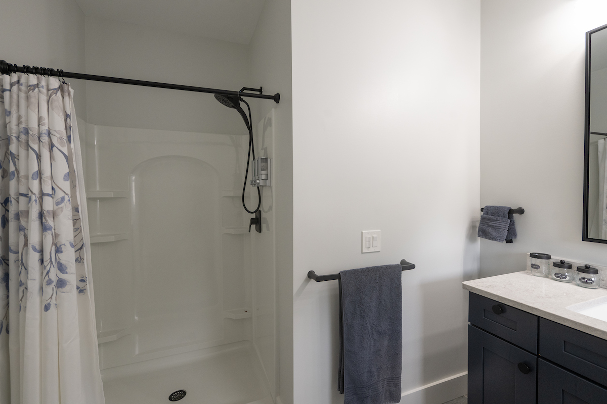 Bathroom shower detail with fixtures and curtain rod in Dover NH