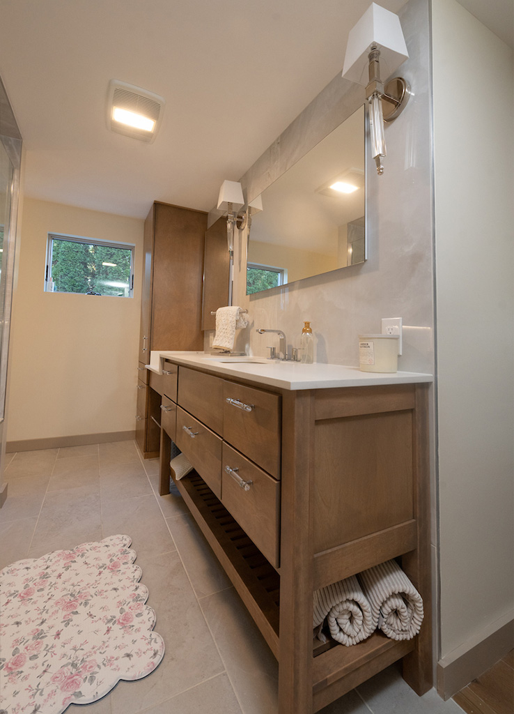Custom wood vanity with stone countertop in Goffstown bathroom by Serenity Baths
